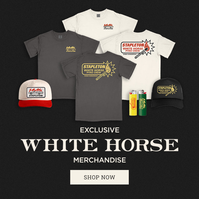 Collection of White Horse merchandise including t-shirts, hats, and cans on a black background.